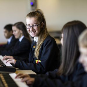 girls practicing the keyboard