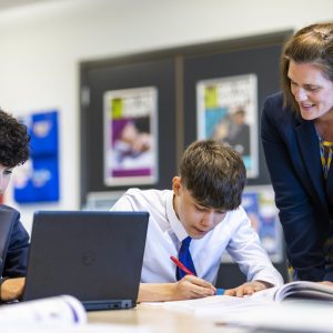 teacher helping boys