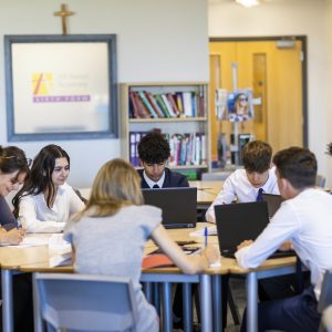 students sat at a table doing their work