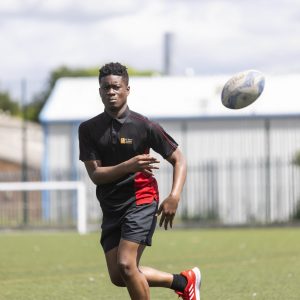 boy throwing a rugby ball