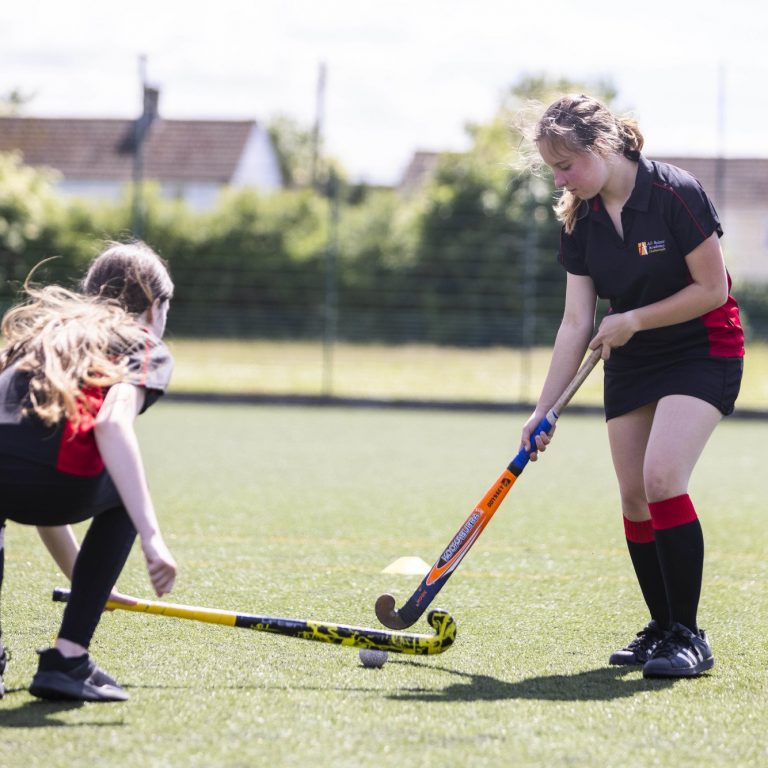 two girls playing hockey