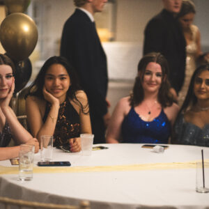 students sat at their table at prom